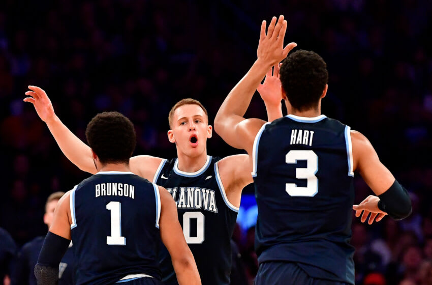 NEW YORK, NY - JANUARY 14: Marvin Clark Jr. #10 congratulates his teammates Jalen Brunson #1 and Josh Hart #3 of the Villanova Wildcats after a basket against the St. John's Red Storm at Madison Square Garden on January 14, 2017 in New York City. (Photo by Steven Ryan/Getty Images)